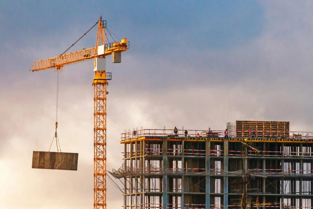 Building site with a tower crane and a structure under construction