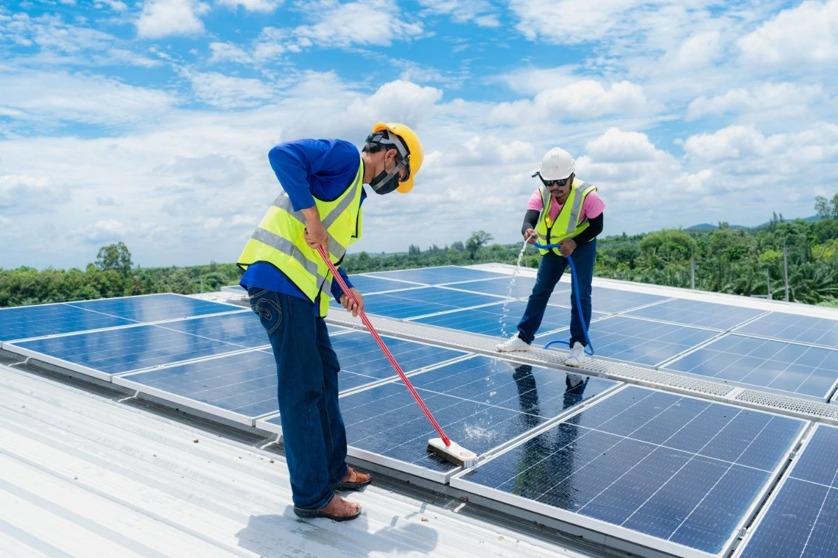 Solar technicians maintaining rooftop solar panels